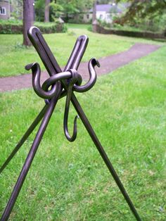 a metal object in the grass near a path