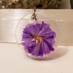 I handmade this pendant using resin and dried flowers.  It will come as completed necklace with 20 in chain. Handmade Resin Flower Pendant Necklace, Resin Necklace With Pressed Flower Pendant, Resin Necklace With Pressed Flowers In Round Pendant, Resin Birth Flower Pendant Necklace, Round Resin Pendant Necklace With Pressed Flowers, Purple Circle, Using Resin, Michigan City, Flower Circle