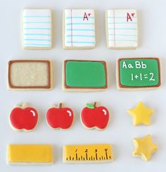 there are some cookies that have different shapes and sizes on them, including apple, star, ruler