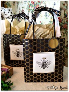 two bags with bees on them sitting on a table