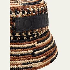 Loewe bucket hat in multicolor woven raffia Features a leather logo patch on the front Flat crown Downturn brim Logo chin strap Raffia/cotton/leather Imported Designer Curved Brim Hat For Vacation, Designer Beach Hat With Curved Brim, Designer Bucket Hat For Beach, Designer Bucket Hat For The Beach, Designer Brimmed Beach Hats, Designer Wide Brim Beach Hat, Designer Wide Brim Hat For Beach, Designer Wide Brim Hat For The Beach, Luxury Summer Bucket Hat