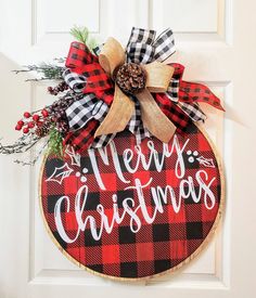 a red and black plaid christmas ornament hanging on a door