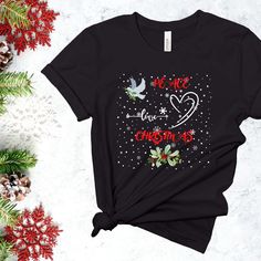 A Christmas Themed Tee for a Festive Celebration Shirt. Trendy T-shirt for a Christmas Party Shirt and a Christmas Tshirt with Holiday Designs for Holiday Festivities. HOW TO ORDER Choose a shirt from the shop by clicking on the shirt. Choose Color and Size (refer to size Chart) Select the Quantity you are purchasing. Click ADD to CART If there is a sale or a coupon code, make sure it has been applied at checkout. Check your email inbox for a 15% off coupon on your next purchase from my store. THANKS FOR ORDERING  MATERIAL AND FIT Made in the USA All solid colors are made from 100% airlume combed and ringspun cotton. Heather Colors are a blend made from 52% cotton and 48% polyester. Light and breathable fabric Shirts fit true to Size. The shoulders have taping for a better fit over time. D Black Top As Christmas Gift, Black Short Sleeve T-shirt For Festive Occasions, Christmas Crew Neck Shirt Gift, Christmas Graphic Tee Shirt Gift, Christmas Graphic Tee As Gift, Christmas Gift Crew Neck Shirt, Graphic Print Top As Christmas Gift, Holiday Graphic Print T-shirt, Holiday Gift Cotton T-shirt