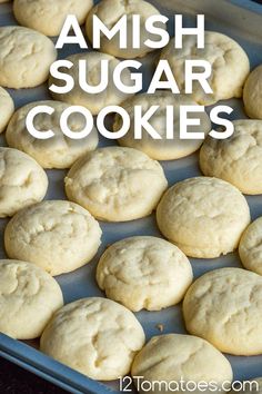 some cookies are sitting in a pan on a table with the words, amish sugar cookies