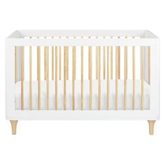 a white crib with wooden slats on the bottom and sides, against a white background