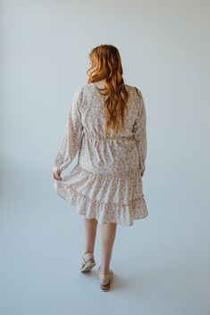 This beautiful neutral midi-length dress has all of the boho vibes! It is going to be your new go-to for date nights, weddings, and work events. This dress features a modest, shorter v-neckline and fluttery blouson long-sleeves. The blousy material flows beautifully down the dress's skirt, with the bottom featuring a tiered effect edged by ruffles. The smocked waist gives the dress an a-line fit that will accentuate your curves beautifully and provide structure to this extra flowy dress. The lin Long Sleeve Boho Dress, Date Nights, Midi Length Dress, Boho Vibe, Flowy Dress, Faux Leather Jackets, Boho Dress, Midi Length, Date Night