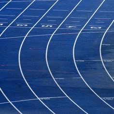 an athlete is running on the blue track