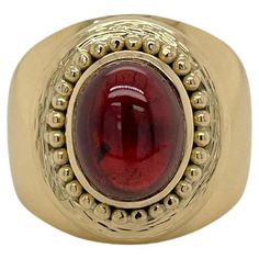 Ring contains one center 9.7x7.7mm oval cabochon garnet, approximately 2.50cts. Surrounding oval garnet are 18K yellow gold bead accents. Widest part of ring measures 17.5mm. Ring weighs approximately 12.3 grams and is a size 6.75. Please request customization for ring resizing. 18k Yellow Gold Ring, Yellow Gold Ring, Oval Cabochon, Yellow Gold Rings, Gold Beads, Cocktail Rings, Gold Ring, Garnet, Gold Rings