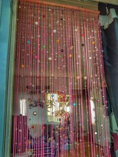 the window is decorated with beads and streamers