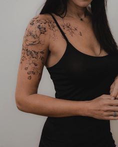 a woman with tattoos on her arm and shoulder