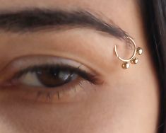 a woman's eye with a nose piercing on it