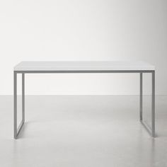 a white table sitting on top of a cement floor