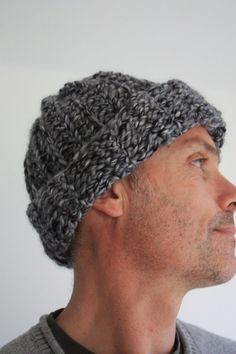 a man wearing a knitted hat looking up