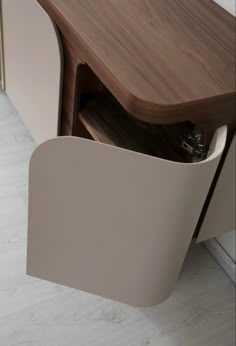 a close up of a wooden cabinet with an open drawer on the front and side