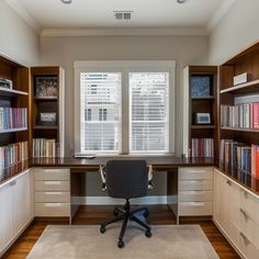 a home office with built in bookshelves, desk and chair on carpeted floor