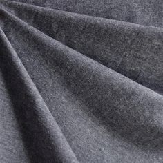 a close up view of the fabric on a grey shirting material that is very soft