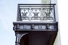 an ornate balcony with wrought iron railing and balconies on the side of a building