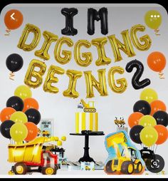 i'm digging being 2 birthday party decoration with balloons and construction vehicles, including a dump truck