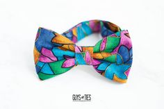 "A fun artsy floral bow tie with a colorful 90s design. A great option to adorn those springtime outfits, even have fathers and sons matching. A vibrant and bright accessory! Colors include a soft blue, golden orange, magenta pink, kelly green, aqua blue and metallic gold. The listing pictures show the 'adult bow tie' size which is a pre-tied adult bow tie. SIZE OPTIONS EXPLAINED BELOW: Baby Bow Tie -  * pre-tied 1.75\" x 3.5\" bow * neck strap adjusts 9\"-11\" with velcro attachments * recommended 3M-18M for average size Toddler Bow Tie -  * pre-tied 2\" x 3.75\" bow * neck strap adjusts 11\"-13\" with velcro attachments * recommended 24M-3yrs Kids Bow Tie - * pre-tied 2.25\" x 4.25\" bow * neck strap adjusts up to 14\" with metal hardware attachments * recommended 4yrs-12yrs Teenager Bow Multicolor Bow Tie For Summer Gift, Springtime Outfits, Untied Bow Tie, Pink Kelly, Spring Time Outfits, Toddler Bow Ties, Baby Bowtie, 90s Design, Floral Bow Tie