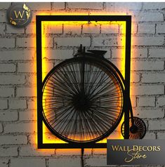 the wall - decors store is displaying an old bicycle wheel with neon lights on it