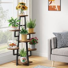 a living room filled with lots of plants next to a wall mounted planter that says multi - function & save space only need a small spot to brighten your life