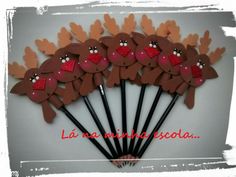 a bunch of brown and red reindeer hair sticks with hearts on them in the shape of antlers