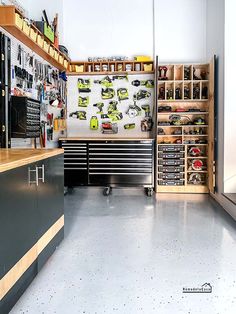 a garage with lots of tools on the wall and shelves filled with various types of tools