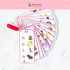 the pink bookmarks have pictures of animals and letters on them, along with a red pen