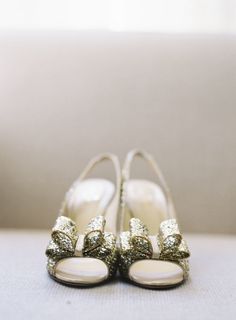 the bride's shoes are adorned with gold sequins and bowknots