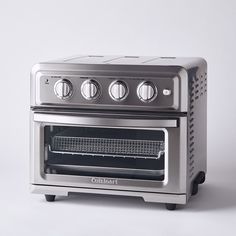 a silver toaster oven sitting on top of a white counter