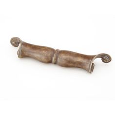 an antique brass drawer pull handle with scrolled handles on a white background for use in furniture and home decor