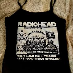 Radiohead Aesthetic Crop Top | Spaghetti Strap Baby Tee | Gothic Grungecore Fashion Show Your Love For Radiohead With This Stylish Band Tee Shirt Crop Top Featuring A Spaghetti Strap Design And Made From Stretchy Spandex, This Baby Tee Combines Comfort And Aesthetic Appeal. Perfect For Fans Of Gothic, Grungecore, Coquette And Punk Styles, This Versatile Top Is Ideal For Layering Or Wearing On Its Own To Showcase Your Unique Fashion Sense. #Radiohead #Bandtee #Croptop #Spaghettistrap #Gothfashion Edgy Summer Tops With Graphic Design, Edgy Graphic Tops For Summer, Edgy Graphic Design Tops For Summer, Trendy Cotton Top For Alternative Fashion, Y2k Graphic Print Tops For Music Festival, Fitted Grunge Tops With Graphic Design, Edgy Fitted Tops With Graphic Design, Grunge Cotton Tops For Summer, Summer Cotton Grunge Tops