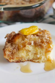 a close up of a piece of cake on a plate with syrup drizzled around it