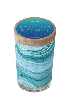 a candle that is sitting on top of a white surface with blue and green swirled wax