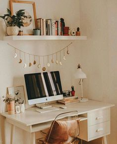 a desk with a computer, chair and bookshelf above it in a home office