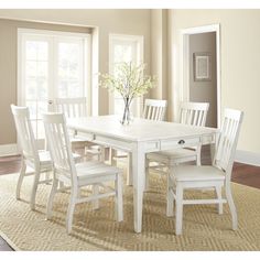 a white table and chairs in a room