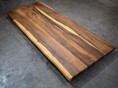 a wooden board sitting on top of a cement floor