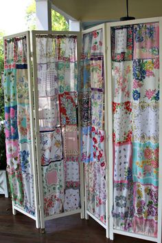 an open room divider covered in colorful fabric