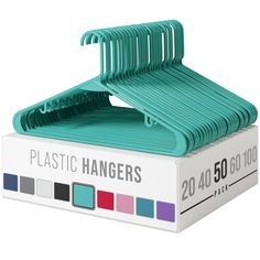 the plastic hangers are in a box on top of each other, with different colors