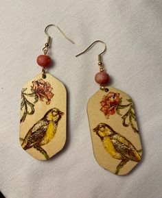 Unique and Elegant Romance - These earrings have been cut from wood and hand painted by me. These are gorgeous statement earrings. Shown wearing to depict size. This listing is for yellow bird color way. As seen on Tik Tok - These wont last! The perfect gift for a 5 year anniversary, yourself, someone you love, co-worker or bird lover. Each set of earrings will come beautifully packaged for gift giving. Made with nickel free gold tone ear wires and findings. Glowforge cut, Enamel Paint for a lus Painted Wood Art, 5 Year Anniversary, Wood Painting Art, Romantic Jewelry, Romantic Jewellery, Yellow Bird, Bird Lover, Enamel Paint, Hand Painted Wood