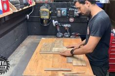 a man is working with wood in a shop