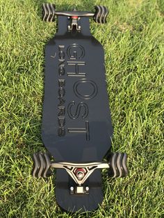 a skateboard laying in the grass on top of it's back legs and wheels