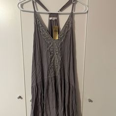 This Dress Is From American Eagle And It Is Listed As Being One Size, Which Means That It Will Fit If You Are An Xs-Xl. This Dress Is Purple And It Has Lace That Goes Down The Center Of The Dress. This Dress Is Oversized And It’s Perfect To Throw Over A Bathing Suit And Go To The Beach In! It’s Stylish And Still Very Functional. The Straps Are Adjustable Depending On What Size You Are. This Dress Is Brand New With The Original Tags Still Attached And It’s In Excellent Condition As It’s Never Bee Gray Spaghetti Strap Spring Dress, Gray Spaghetti Strap Summer Dress, Gray Spaghetti Strap Dresses For Spring, Gray Summer Dresses With Spaghetti Straps, Sleeveless Gray Vacation Dress, Gray Sleeveless Vacation Dress, Gray Sleeveless Dress For Vacation, Summer Cotton Mini Dress In Gray, Gray Cotton Mini Dress For Summer