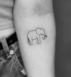 an elephant tattoo on the left inner arm is shown in this black and white photo