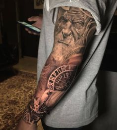 a man with a tattoo on his arm that has a clock and an old man's face