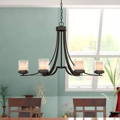 a chandelier hanging over a dining room table