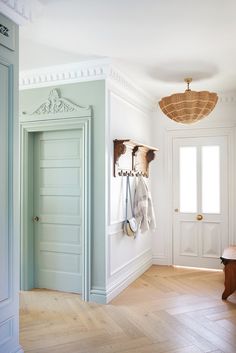 an empty entryway with two coats hanging on hooks