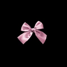 a pink bow on a black background