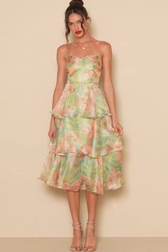 Springtime soirees just got a little sweeter now that the Lulus Darling Aesthetic Green Floral Print Tiered Midi Dress is on the scene! Airy woven organza boasts a lush floral print as it shapes adjustable spaghetti straps and a bodice with surplice-inspired seaming that gives an overlapping effect. Fitted waist sits above a skirt that falls in floaty tiers to a midi hem. Hidden zipper/clasp at back. Fit: This garment fits true to size. Length: Mid-calf length. Size medium measures 41" from adju Organza Midi Dress, Midi Dress Floral, Aesthetic Green, Lulu Fashion, Green Floral Print, Tiered Midi Dress, Green Aesthetic, Spring Time, Mid Calf