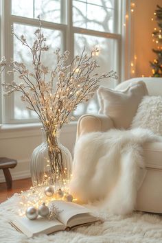 a living room filled with furniture and a christmas tree in the window sill next to a book